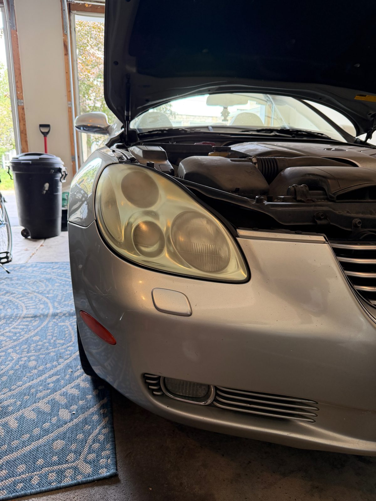 Yellowed headlight restored to clear on a silver Chrysler in Columbus, Ohio before restoration